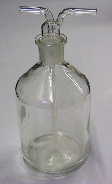 A photo showing a gas washing bottle made from glass that is used in many lab experiments.