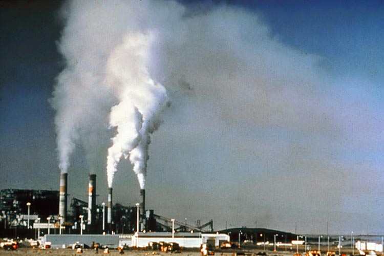 This image shows some of the air pollution problems caused by large smoke stacks before emission control standards were introduced.