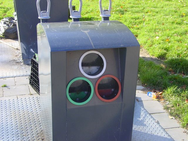 This picture shows a glass recycling bin at a neighborhood collection point for recyclable materials.