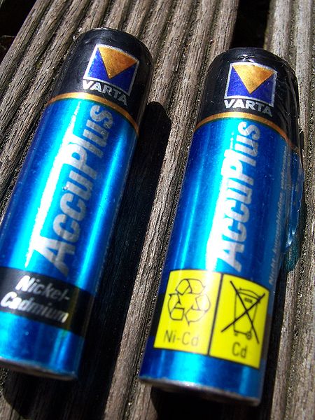 This picture shows two recyclable nickel cadmium batteries lying next to each other.