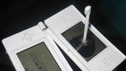 This technology photo features a broken Nintendo DS. The stylus has been put through the upper LCD screen and the hinge has been snapped. The owner obviously found this game particularly difficult.