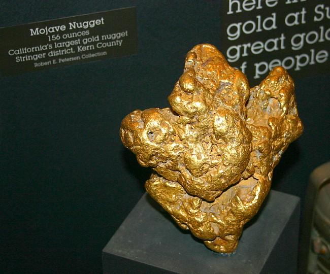 This photo shows an enormous gold nugget. Known as the Mojave Nugget, it weighs 156 ounces and is the largest gold nugget found in California. Gold is a precious metal with the chemical symbol Au.