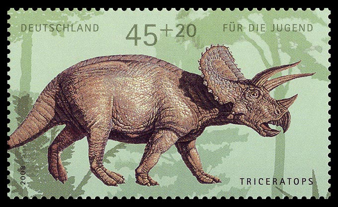 This is a picture of a German postage stamp that features a dinosaur called Triceratops shown walking from a side on view.