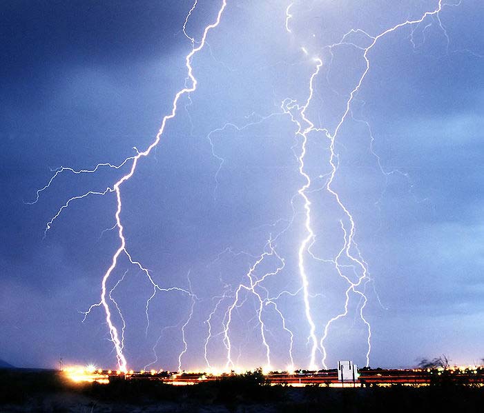 A spectacular photo capturing bright lightning in action as it surges from the sky to the ground, illuminating the sky and creating this beautiful image.