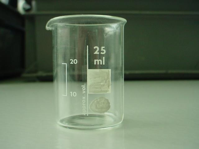 A close up photo of a small beaker. It has marks for the approximate volumes of 10, 20 and 25ml. 
