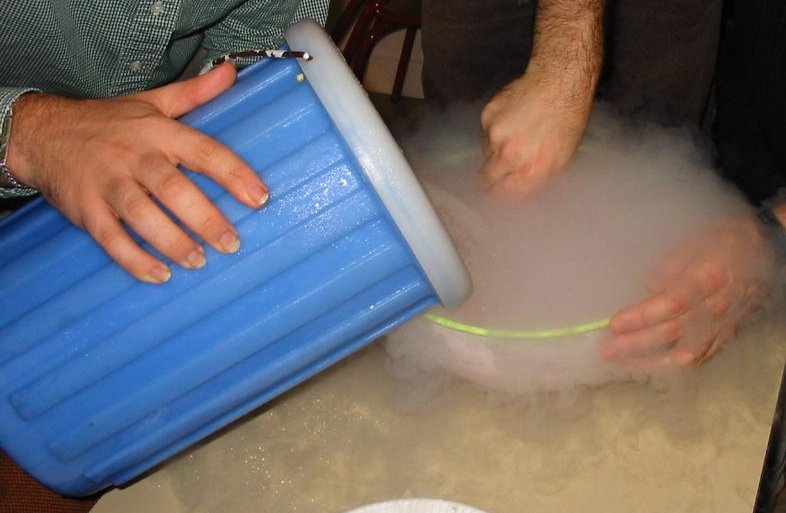 It's all hands on deck as liquid nitrogen is used to help make homemade ice cream in this experiment photo. The liquid nitrogen rapidly freezes the ice cream, creating crystals that are smaller than those that are created from conventional ice cream making methods. These smaller crystals create a smoother texture and creamier ice cream than what is normally produced