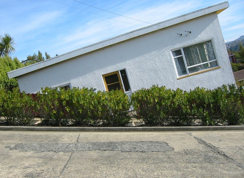 This amusing tilted house illusion can be seen along Baldwin Street in Dunedin, New Zealand. It is one of the steepest streets in the world.