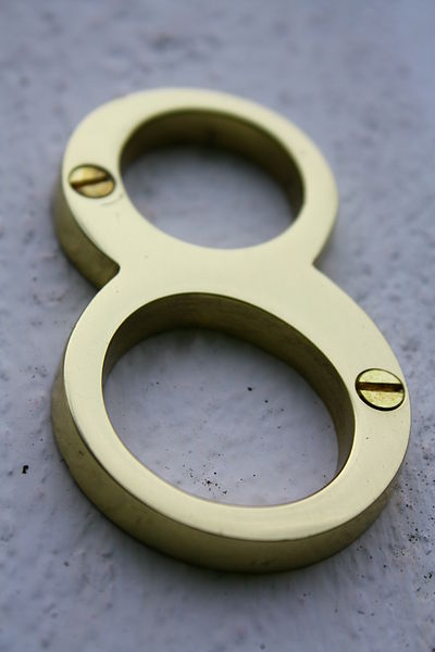 A close up photo of a metal number 8 used to display the street address of a house.