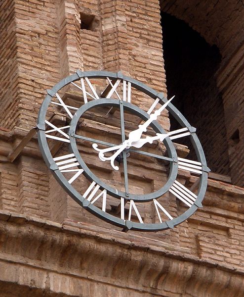 A photo of a clock in Spain with roman numerals.