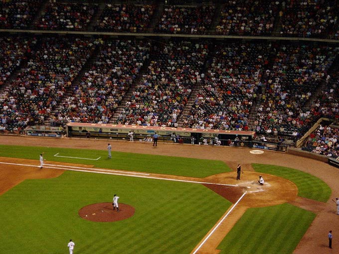 This photo shows a large crowd watching a baseball game in the USA.