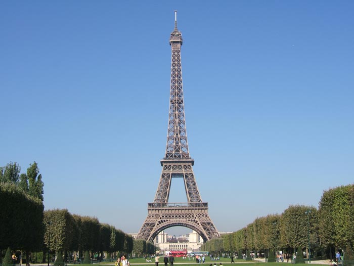 The Eiffel Tower is an iconic structure found in Paris, France. It stands at 324 metres (1,063 ft) tall and is visited by huge numbers of tourist every year. This photo shows the Eiffel Tower set against a blue sky on a beautiful day in Paris.