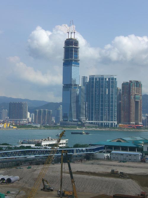 The International Commerce Centre is a huge skyscraper in Hong Kong. One of the tallest buildings in the world, it stands at 483 metres in height (1584 feet). It features 118 floors and can be seen nearing completion in this photo.