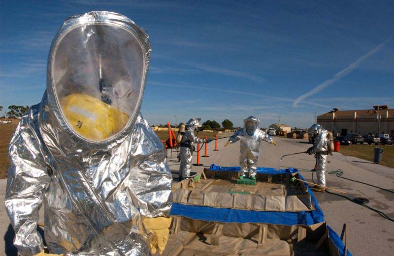 A number of men can be seen wearing silver decontamination flash suits that protect against the serious threat of contamination.