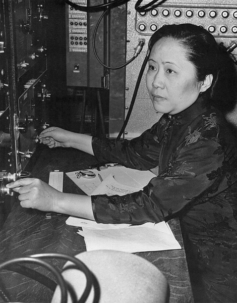 A black and white photo of Chien-Shiung Wu as she adjusted settings while researching experimental physics.